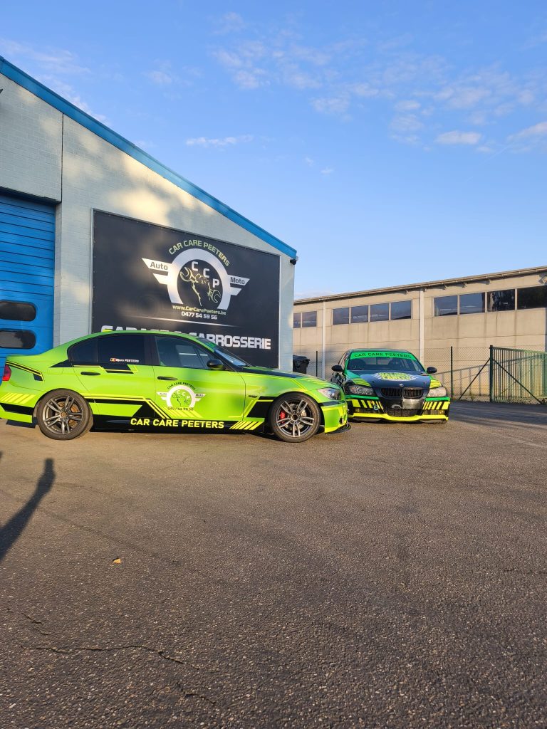 Twee wagens in Car Care Peeters-kleuren voor de werkplaats